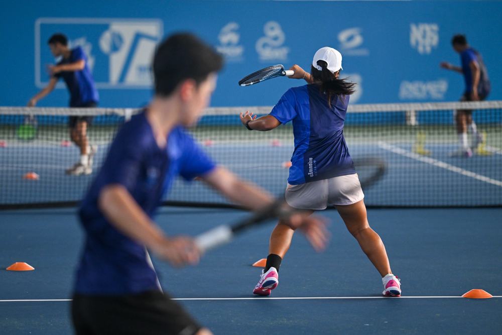 Players training on a TATP tennis court